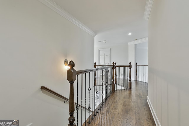 hall with baseboards, ornamental molding, an upstairs landing, recessed lighting, and wood finished floors