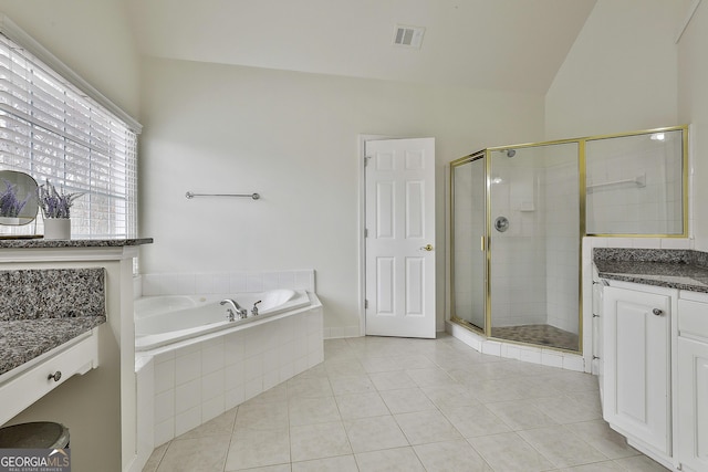 full bath featuring a garden tub, a stall shower, vanity, and vaulted ceiling