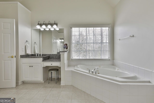 full bath with lofted ceiling, vanity, a whirlpool tub, and tile patterned flooring