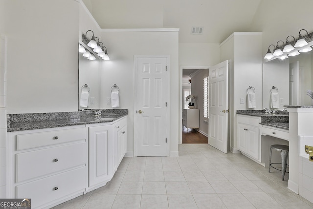 bathroom featuring tile patterned flooring, visible vents, two vanities, and a sink