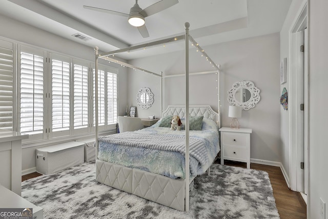 bedroom with visible vents, ceiling fan, baseboards, and wood finished floors