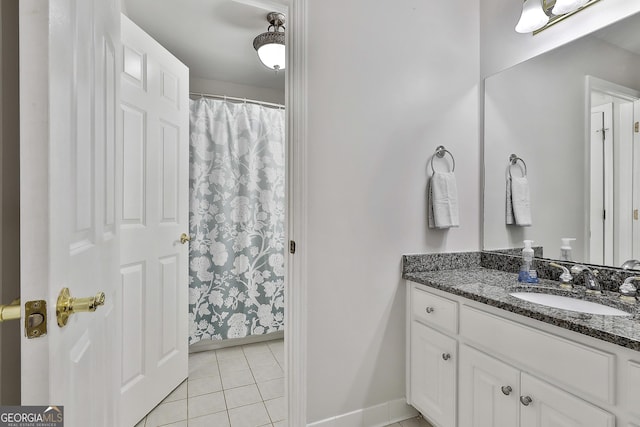 full bathroom with tile patterned floors, curtained shower, baseboards, and vanity