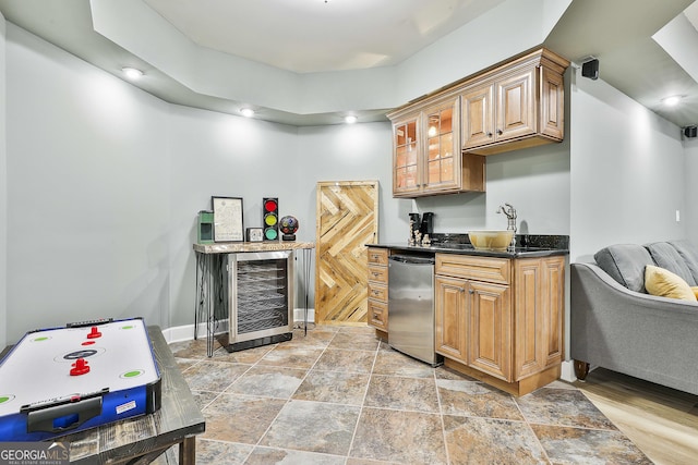 kitchen with beverage cooler, refrigerator, a sink, glass insert cabinets, and dark countertops