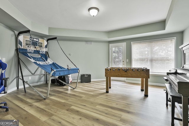 game room featuring light wood-style floors, visible vents, and baseboards