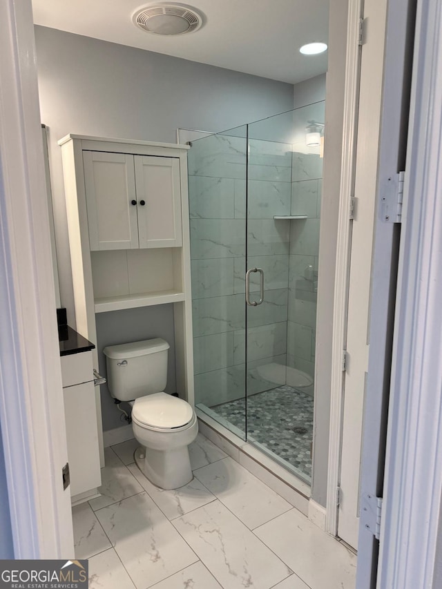 bathroom with visible vents, toilet, marble finish floor, a stall shower, and baseboards