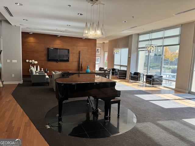 playroom featuring recessed lighting, visible vents, wood walls, and wood finished floors