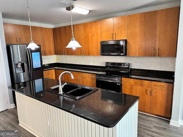 kitchen with brown cabinets, dark wood-style flooring, appliances with stainless steel finishes, and a sink