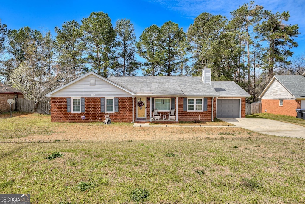 3431 Toms Dr, Augusta, GA 30906 - single story home featuring driveway, covered porch, an attached garage, fence, and brick siding
