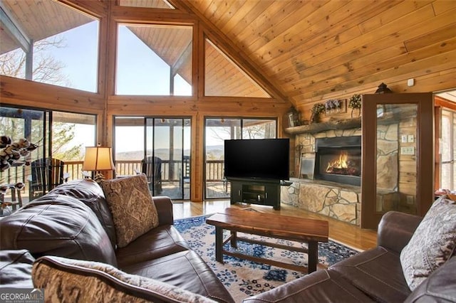 living room with a stone fireplace, wooden ceiling, high vaulted ceiling, and wood finished floors