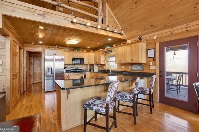 kitchen with wood ceiling, light wood-type flooring, appliances with stainless steel finishes, and light brown cabinetry