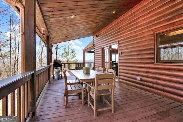 wooden terrace featuring outdoor dining area