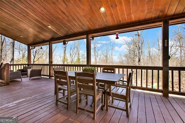 sunroom with a healthy amount of sunlight and wooden ceiling