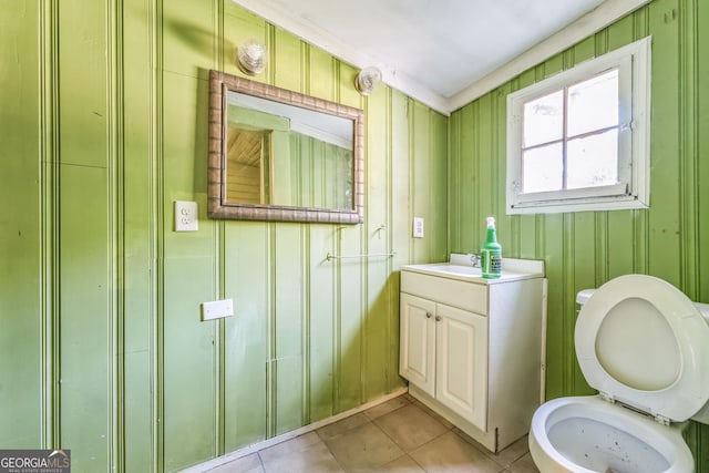 bathroom featuring tile patterned flooring, toilet, and vanity