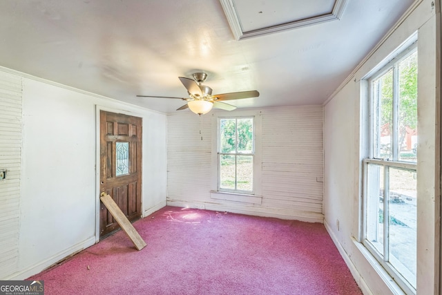 empty room with baseboards, ceiling fan, carpet flooring, and crown molding