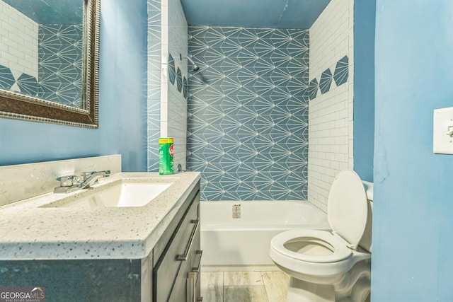 full bath with toilet, wood finished floors, and vanity