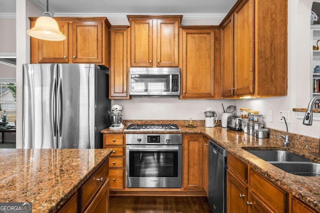 kitchen with a sink, ornamental molding, brown cabinets, and stainless steel appliances