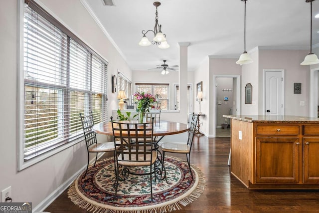 dining room with dark wood finished floors, ceiling fan with notable chandelier, baseboards, and ornamental molding