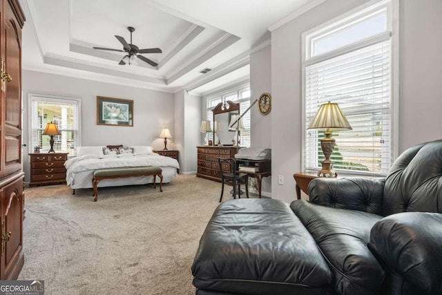 bedroom featuring visible vents, ceiling fan, ornamental molding, a raised ceiling, and light colored carpet