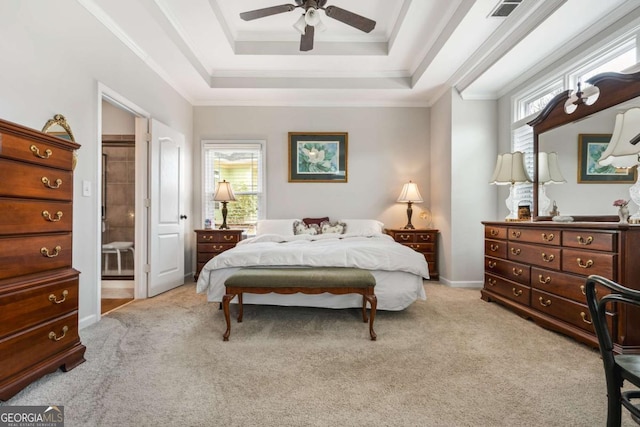 bedroom with a tray ceiling, crown molding, multiple windows, and light colored carpet