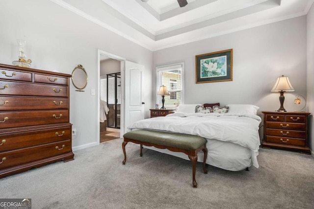 carpeted bedroom featuring a tray ceiling, baseboards, ornamental molding, and a ceiling fan