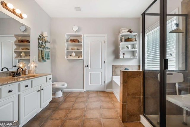 bathroom with vanity, a bath, visible vents, tile patterned floors, and toilet