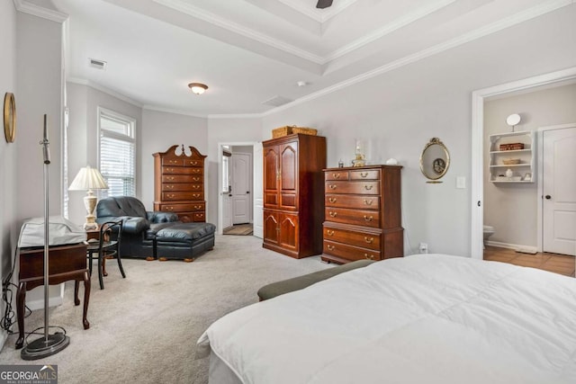 bedroom featuring visible vents, light colored carpet, ensuite bathroom, and ornamental molding