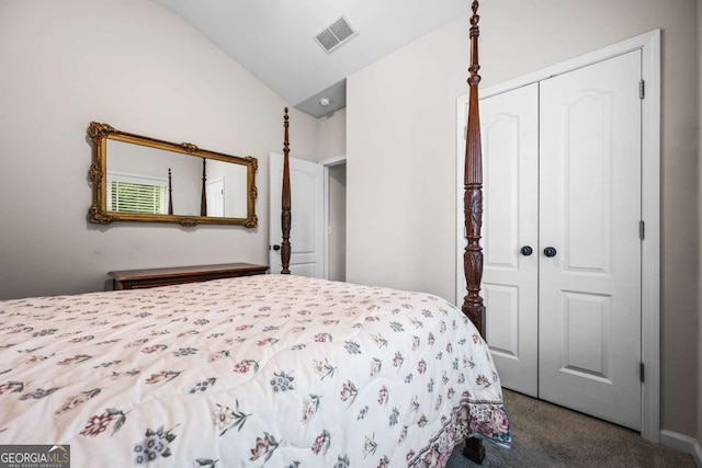 bedroom featuring visible vents, a closet, carpet flooring, and vaulted ceiling