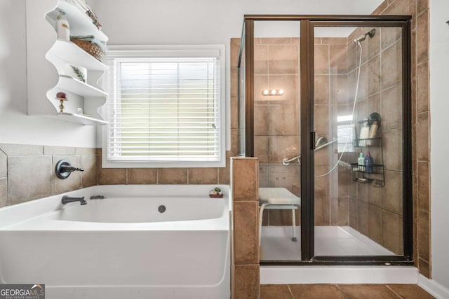 full bath with tile patterned floors, a stall shower, and a bath