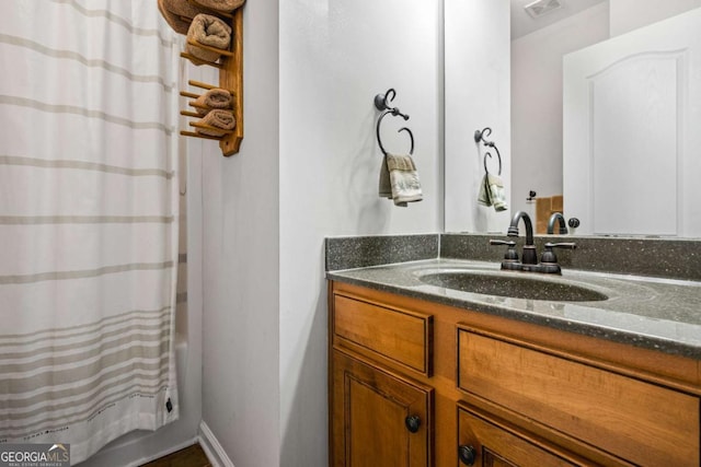 bathroom with visible vents, shower / tub combo, and vanity