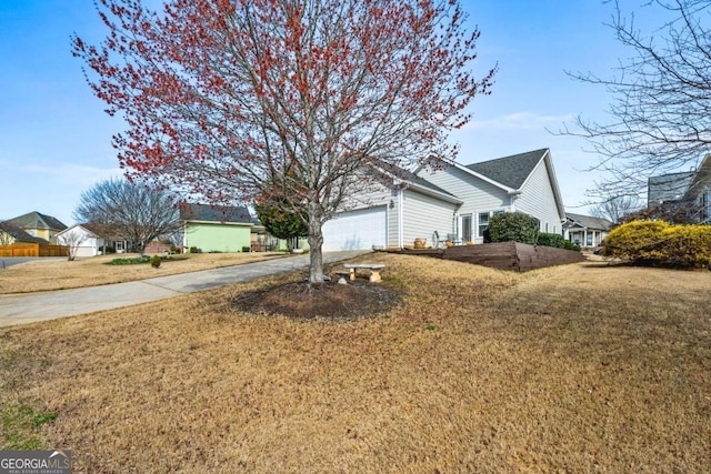 view of home's exterior featuring a lawn, concrete driveway, and an attached garage