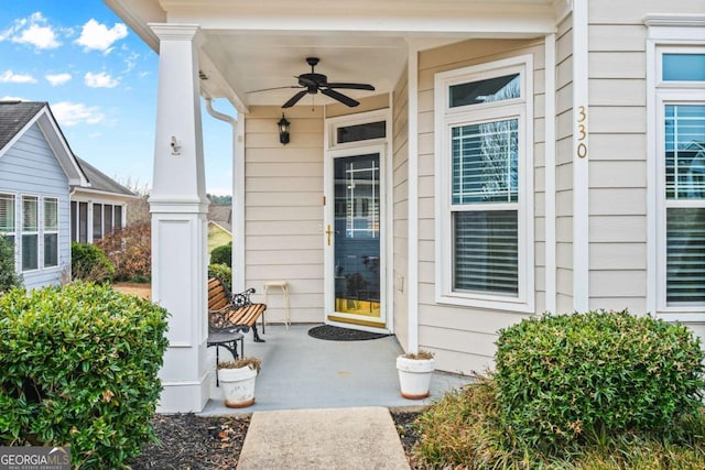 entrance to property featuring covered porch and ceiling fan