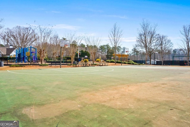 view of sport court with community basketball court, playground community, and fence