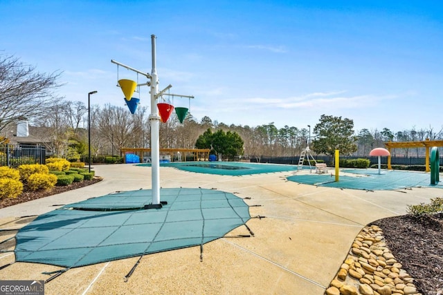 community pool featuring community basketball court, fence, and a patio