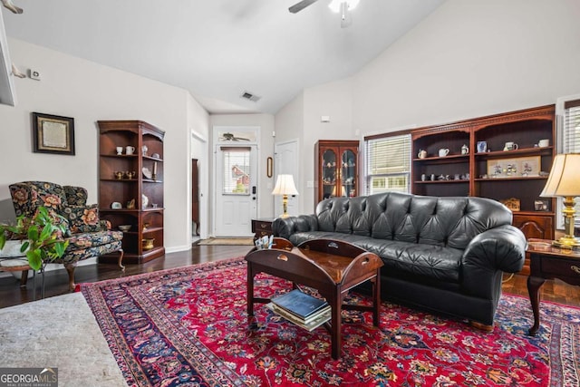 living room featuring visible vents, wood finished floors, high vaulted ceiling, and ceiling fan