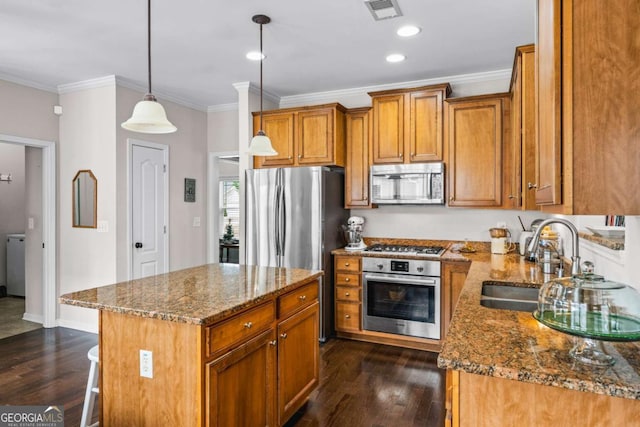 kitchen featuring visible vents, a sink, appliances with stainless steel finishes, stone counters, and dark wood-style flooring