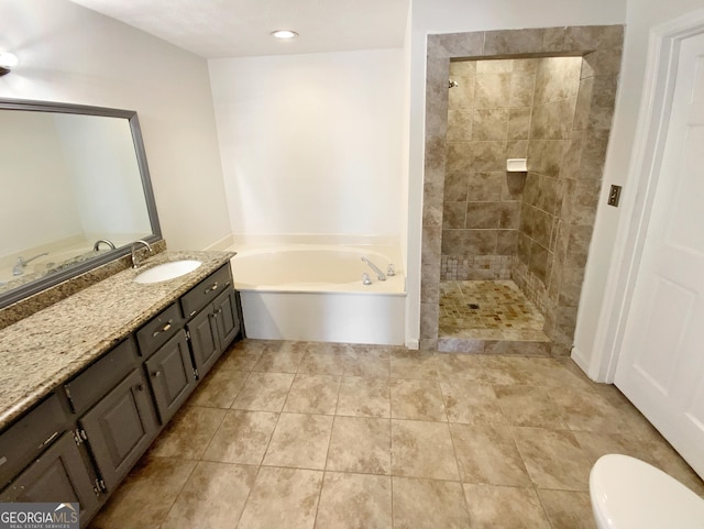 bathroom with toilet, tiled shower, vanity, and a garden tub