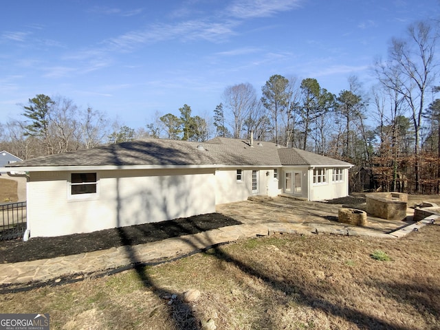 rear view of property with a patio area and french doors