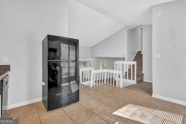 5338 Timor Trl, Lithonia, GA 30038 - hallway with tile patterned flooring, lofted ceiling, a textured ceiling, and an upstairs landing