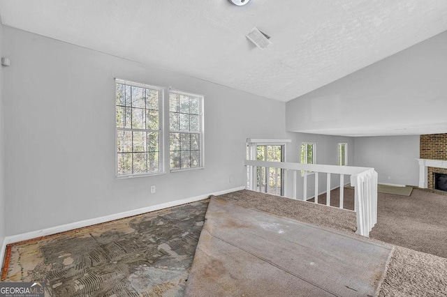 5338 Timor Trl, Lithonia, GA 30038 - unfurnished room featuring a fireplace, carpet floors, lofted ceiling, a textured ceiling, and stairs