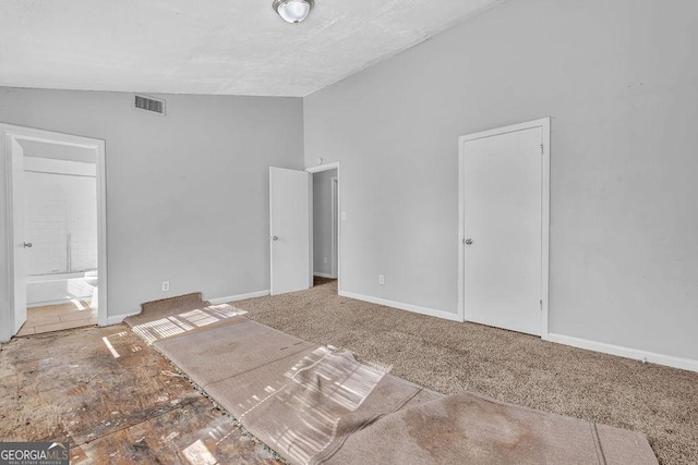 5338 Timor Trl, Lithonia, GA 30038 - unfurnished bedroom with lofted ceiling, ensuite bathroom, and carpet