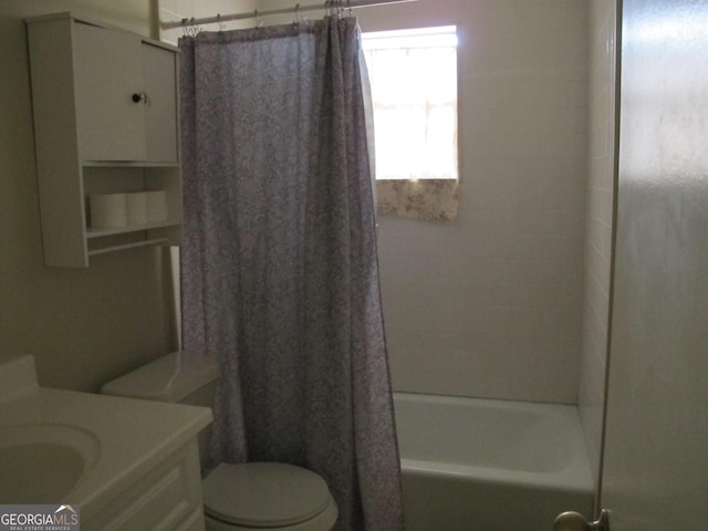 full bath with toilet, vanity, and shower / tub combo