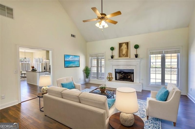 915 Cruce Lake Dr, Hoschton, GA 30548 - living room with dark wood finished floors, a ceiling fan, visible vents, and a fireplace with raised hearth