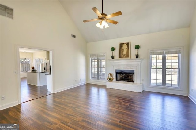 915 Cruce Lake Dr, Hoschton, GA 30548 - unfurnished living room with a healthy amount of sunlight, a fireplace with raised hearth, visible vents, and ceiling fan