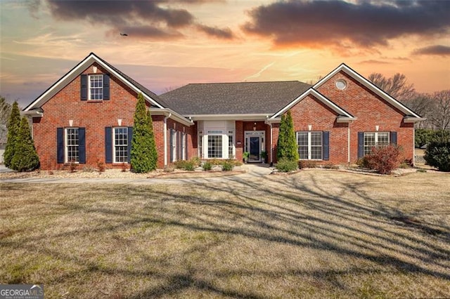 915 Cruce Lake Dr, Hoschton, GA 30548 - view of front of home with brick siding and a front lawn