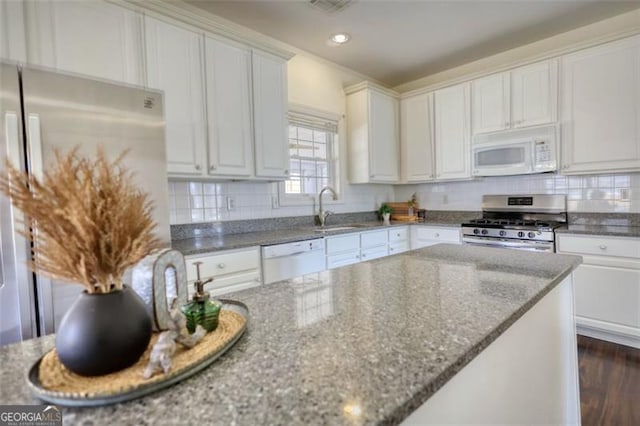 915 Cruce Lake Dr, Hoschton, GA 30548 - kitchen featuring stone counters, a sink, decorative backsplash, stainless steel appliances, and white cabinets