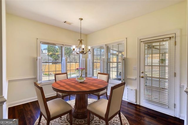 915 Cruce Lake Dr, Hoschton, GA 30548 - dining space featuring visible vents, baseboards, dark wood-type flooring, and an inviting chandelier