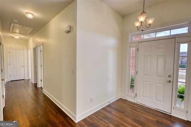 915 Cruce Lake Dr, Hoschton, GA 30548 - foyer featuring dark wood finished floors, a chandelier, and baseboards