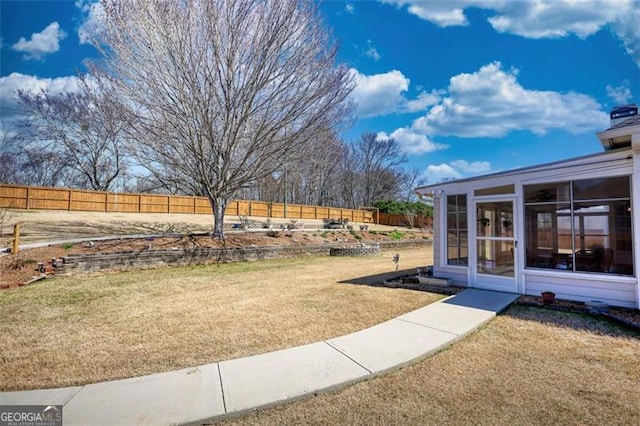 915 Cruce Lake Dr, Hoschton, GA 30548 - view of yard featuring a fenced backyard and a sunroom