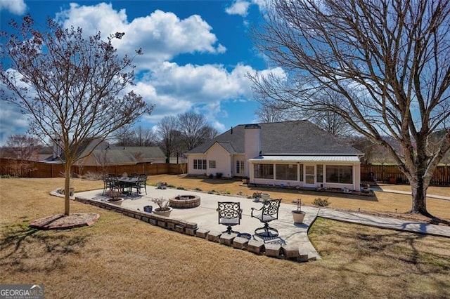 915 Cruce Lake Dr, Hoschton, GA 30548 - rear view of house featuring a patio area, a lawn, a fire pit, and a fenced backyard
