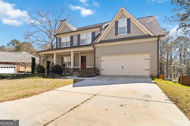 craftsman-style house featuring a front yard, fence, driveway, a porch, and board and batten siding